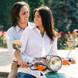 Affirming couple on scooter