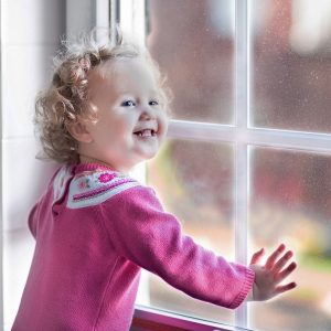 Toddler rejoices at window