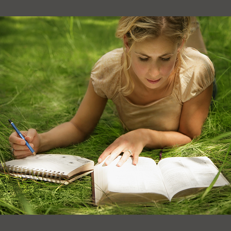 Young woman reading outdoors