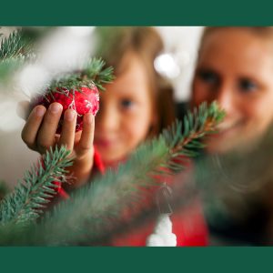 Mother and daughter decorate Christmas tree